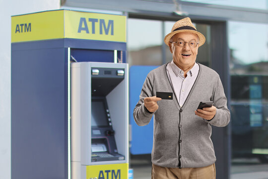 Happy senior with a smartphone and credit card