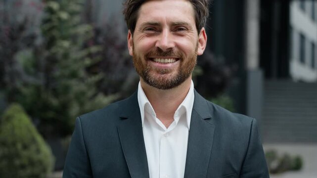 Portrait happy satisfied middle-aged Caucasian business man smiling toothy candid looking at camera in city near office building. Close up 40s businessman male specialist agent executive smile joyous