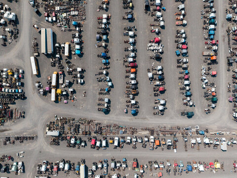 Aerial view of a large salvage yard filled with rows of parked trucks, trailers, and various vehicle parts in Umatilla, Oregon, United States.