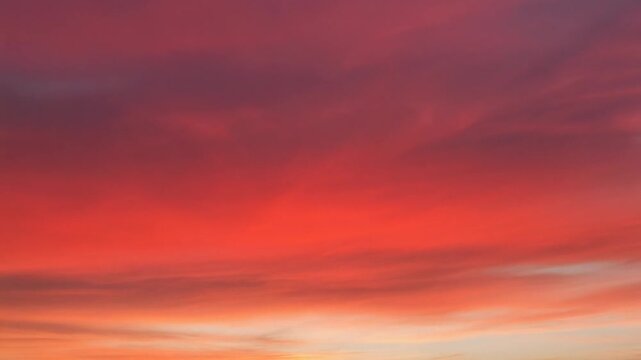 The dramatic sky glows with vibrant shades of deep red and orange during sunset.