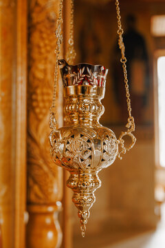 Golden hanging vigil lamp inside historic church, religious sanctuary and faith concept