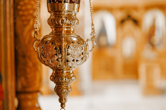 Golden hanging vigil lamp inside historic church, religious sanctuary and faith concept