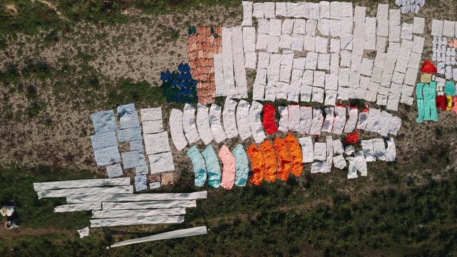 Aerial view of a traditional laundry, dhobi ghat, drying clothes on the ground in rural india
