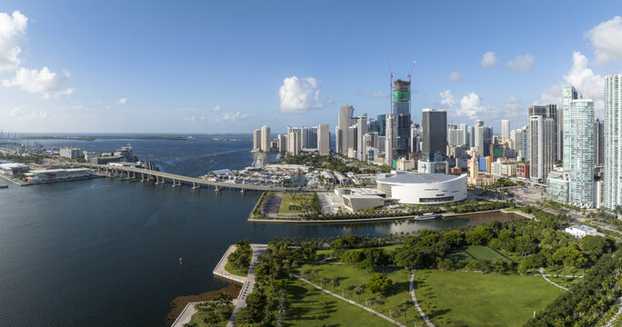 Aerial view of the Downtown Miami skyline, featuring modern skyscrapers, the Kaseya Center, and the MacArthur Causeway bridge over Biscayne Bay in Miami, Florida, United States.