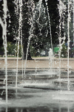 Water fountain jets splashing in city park close up. Urban architecture cooling spray drops. Summer hot weather refreshing, hydraulic infrastructure background.