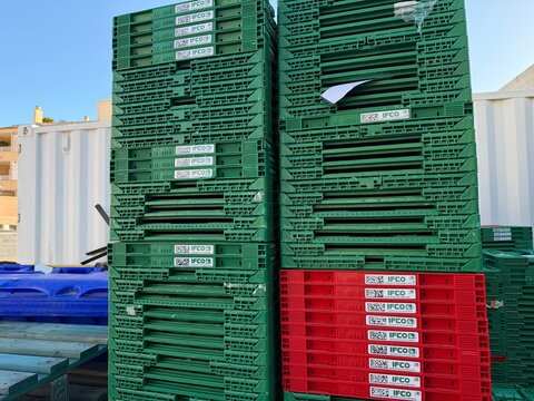 Mallorca, spain, august 30, 2026, stacks of ifco reusable plastic containers for fresh produce supply chain logistics, balearic islands, spain