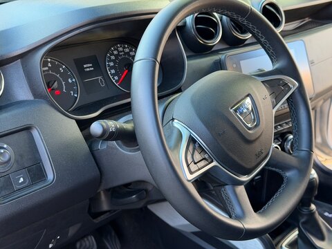 Mallorca, spain, august 30, 2026, dacia duster car interior showing steering wheel, dashboard, and instrument panel from driver's perspective