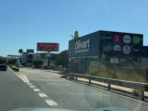 Mallorca, spain, august 30, 2026, commercial street with shopping centers olivart and majorica factory shop, manacor, balearic islands, spain