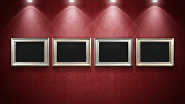 Four illuminated empty picture frames mounted on a red wall gallery