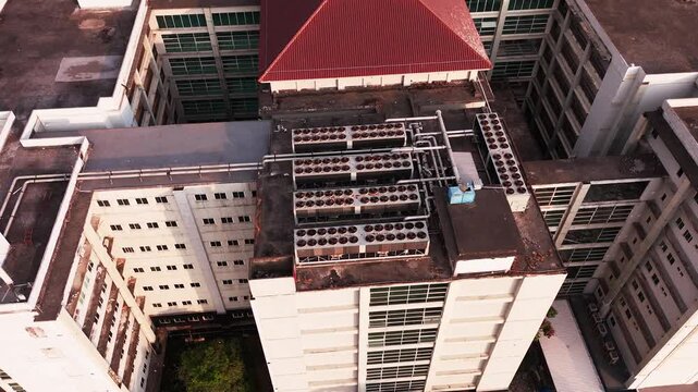 Aerial view of data center rooftop equipped with heavy-duty cooling units, industrial ventilation fans, condenser systems, and pipes for temperature control. Ideal for commercial technology, industria