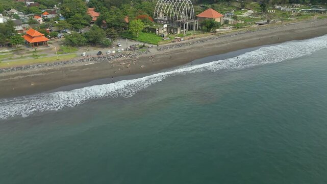 Waves Wash Onto Beach In Sanur Bali Indonesia Drone Track In Towards Abandoned Theme Park Ruins 4K 60FPS
