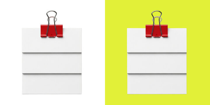 Blank white note papers held by red binder clip