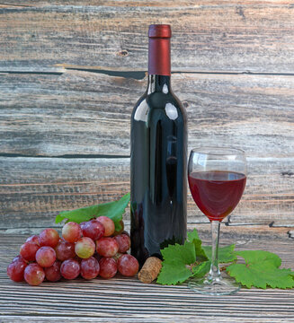 bottle of red wine and grapes