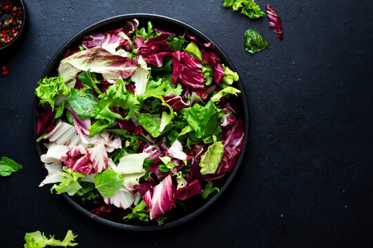 Raw vegetable food healthy green salad in bowl with spices. Organic vegan plant based diet concept for natural wellness nutrition. Fresh vegetarian autumn harvest culinary dinner appetizer recipe.