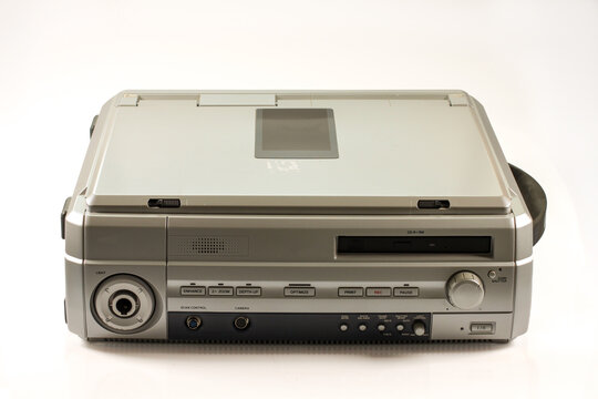 Vintage video recording and image processing device with CD-R/RW drive, camera controls, zoom, recording buttons and light control, isolated on a white background.