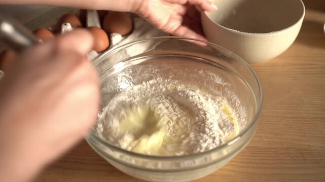 Woman prepares dough for pancakes. Mixing baking ingredients. Cooking, preparing breakfast, dessert