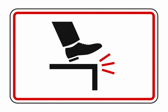 A black silhouette of a foot stepping down onto a surface, indicating a warning about tripping or falling.