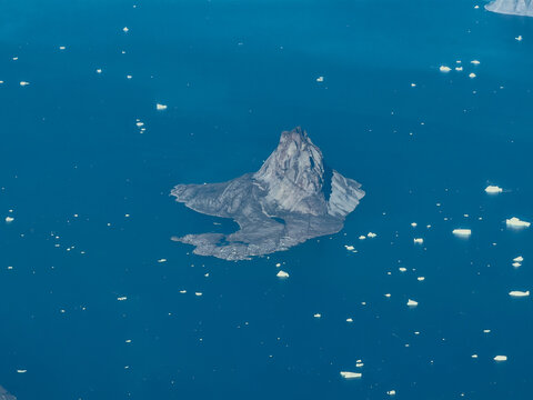 aerial landscape view of Uummannaq Island located in the Uummannaq Fjord in Avannaata municipality in northwestern Greenland with most prominent Uummannaq Twin Peaks mountain at the Arctic Coast