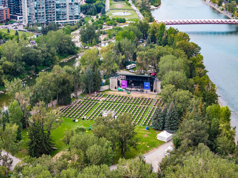 aerial landscape view of parts of Prince's Island next to Bow River with Peace Bridge located in Downtown Calgary ( Alberta, Canada) with Prince's Island Park Stage close to  river bank 