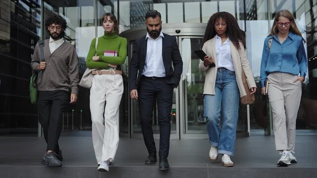 Business People Team walking together with confidence and determination out of workplace - Group of diverse professionals in the city