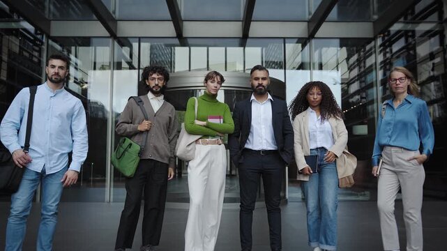 Group of international business people standing together outside a modern office building. Colleagues Team Portrait