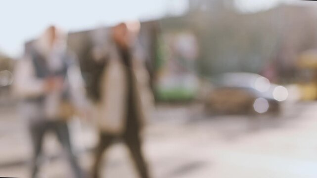 4K slow motion 60 fps footage of defocused people walking on a busy sidewalk in abstract bokeh light on a sunny summer day in the city.