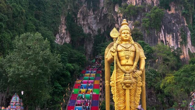 Golden statue of Lord Murugan at the entrance of Batu Caves in Malaysia