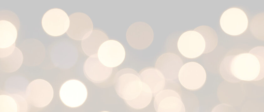 Large soft golden bokeh circles on isolated PNG element is designed for use as a holiday or event background. Warm glowing illuminated holiday light overlay for festive Christmas design.