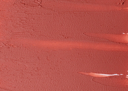 Coral lipstick texture background close up