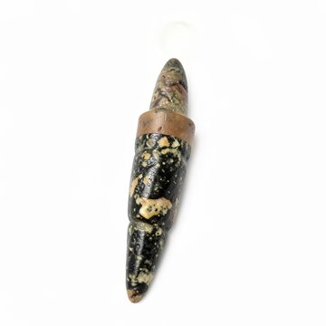 Primitive stone drill with conical point for piercing shells or wood isolated on white background artifact tool