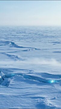 Aerial view of powerful ocean waves crashing against rocky coastline with white foam and deep blue water coastal landscape wave action sea