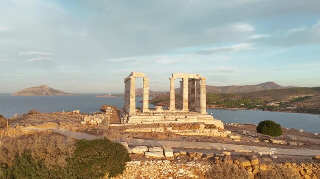 Temple of Poseidon at Cape Sounion, Greece, aerial view at sunset
