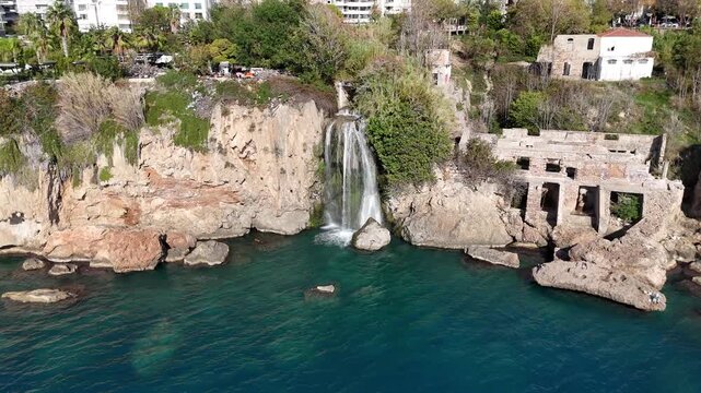 Aerial view of Lower Duden waterfall cascading over rocky cliff into turquoise sea, Antalya, Turkey