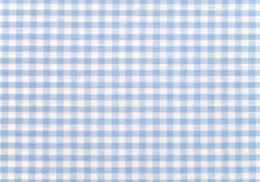 Light blue and white gingham checkered fabric texture background, picnic tablecloth pattern