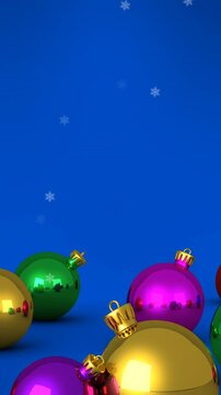 Animation of snow falling over christmas bauble decorations on blue background