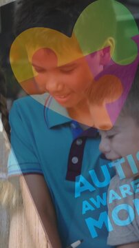 Animation of colourful puzzle pieces and heart over kids friends using electronic devices
