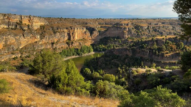 Hoces del Duraton river meander canyon view, Segovia Spain. Wide panorama of horseshoe bend, limestone cliffs and blue sky. High quality 4k footage