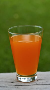 Fresh orange juice in a glass under natural sunlight	