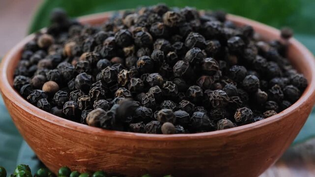 Black peppercorns in a bowl	