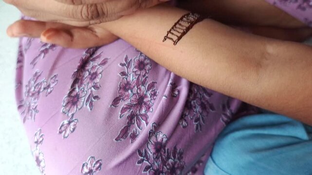 Indian Woman Applying Traditional Henna Mehndi Design on Hand Close Up