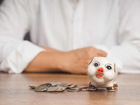 Piggy bank and coins on table for saving money