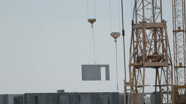Yellow tower cranes at a construction site of a modern building