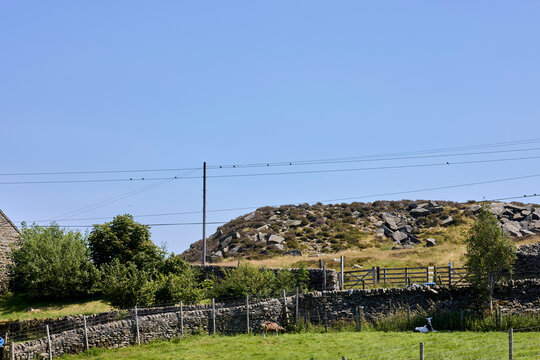 A sunny July day and swallows begin to gather on telephone lines in Nidderdale, North Yorkshire