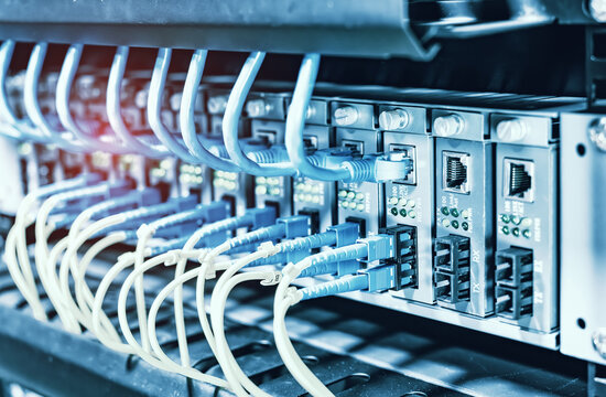 Fiber Optic cables connected to optic ports and UTP, Network cables connected to ethernet ports.