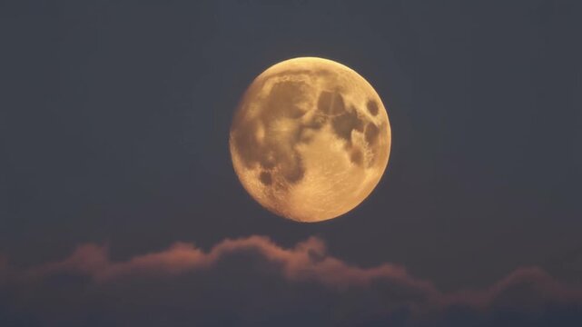 Full moon rising through atmospheric clouds during twilight with subtle cinematic motion