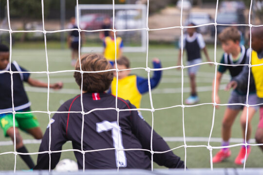 rear view of teenage soccer goalie during match