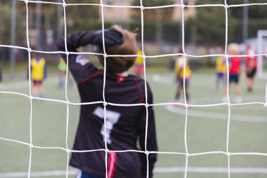 rear view of teenage soccer goalie during match