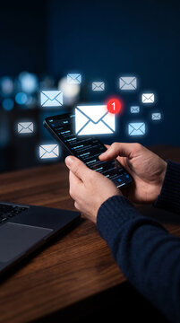 A person holding a smartphone displaying email notifications, symbolizing digital communication and connectivity, relevant for business.