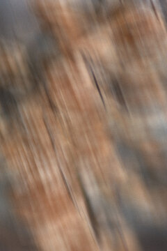 Abstract grainy brown motion blur with vintage texture and dark moody atmosphere. Autumn background