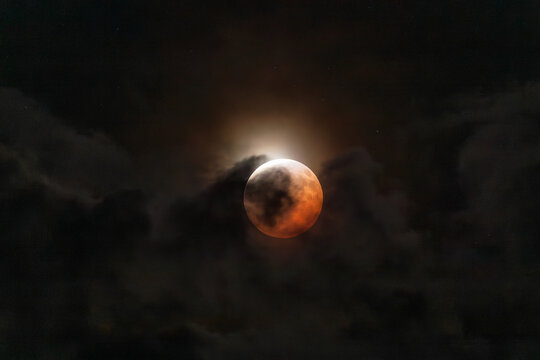 Lunar eclipse with light clouds